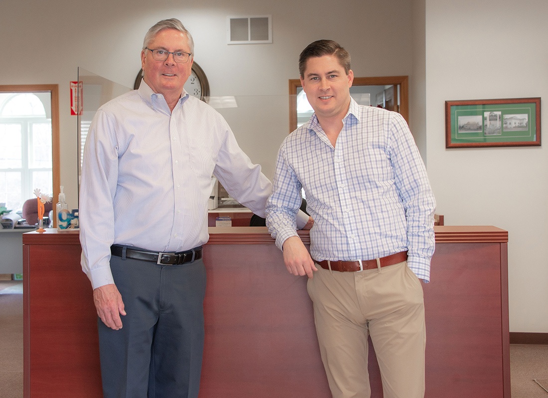 Insurance Solutions - The Moore Insurance Agency Team Standing at the Front Desk Together